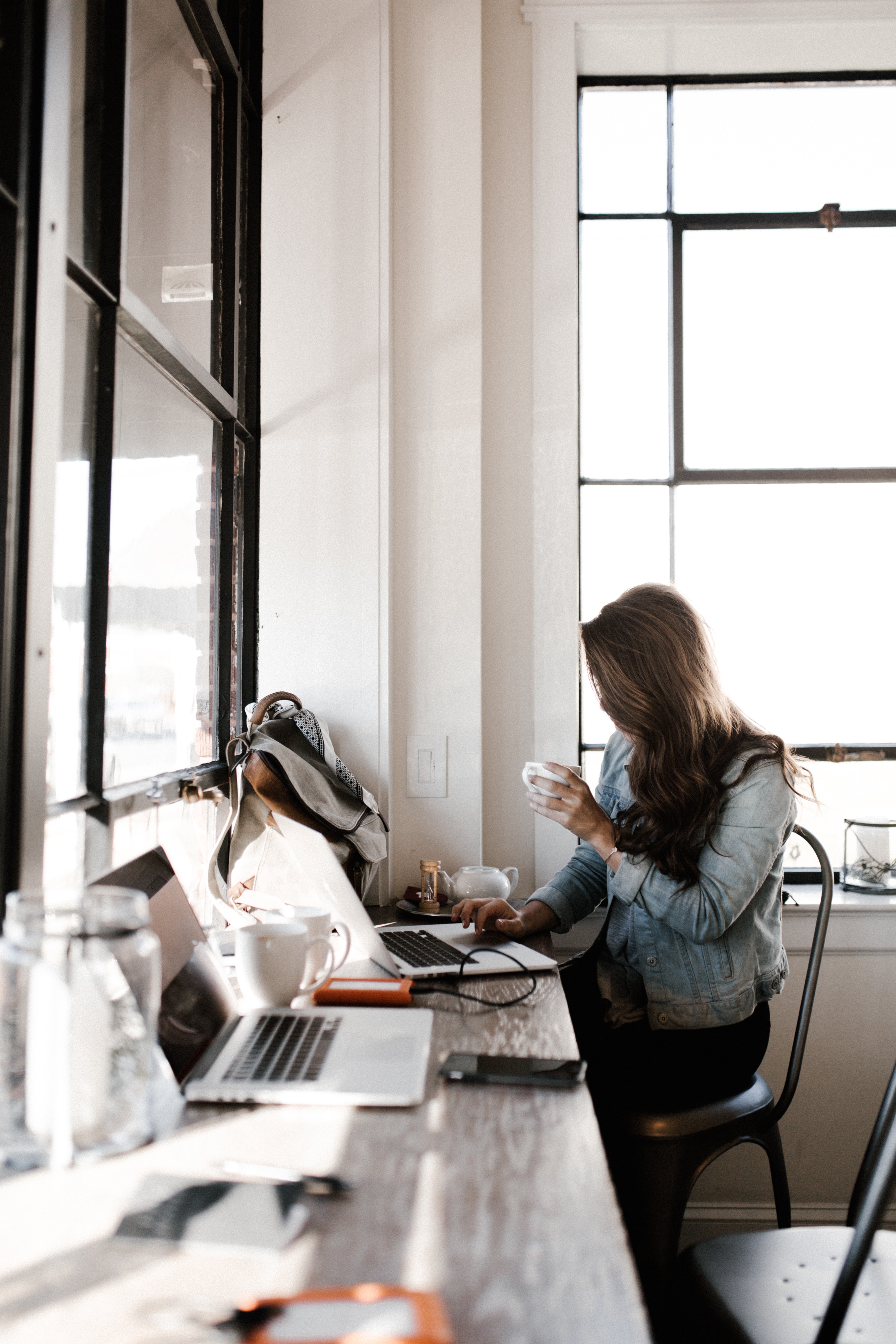 work desk and person next to window